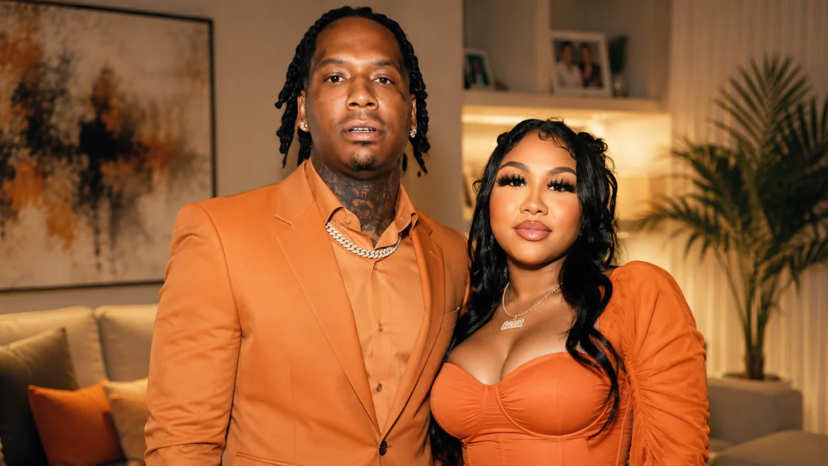 Ari Fletcher Net Worth personal life portrait with a companion in a stylish home setting wearing matching orange outfits