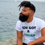 Damon Darling sitting by the water showcasing a relaxed lifestyle and Damon Darling Net Worth success journey.