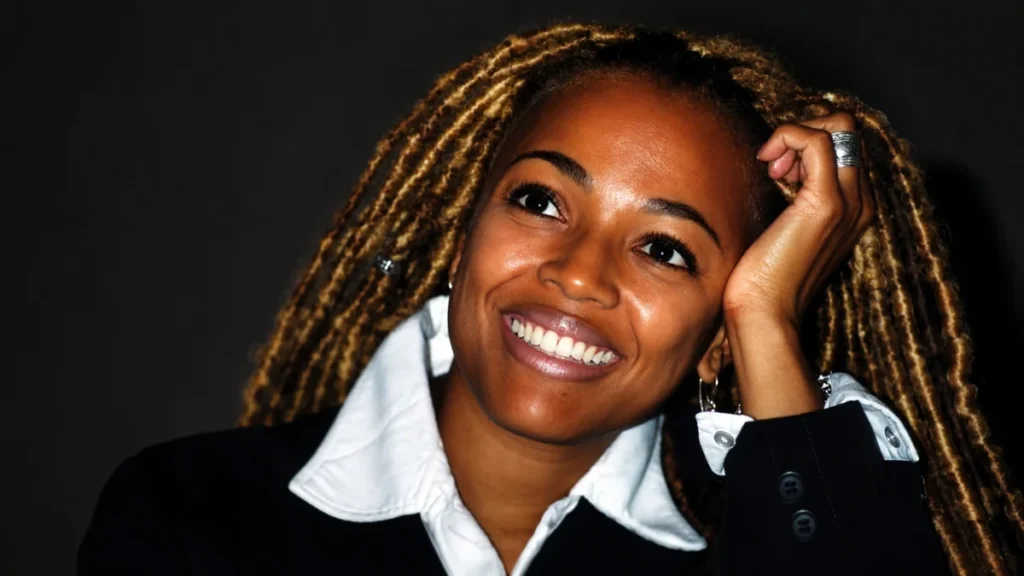 Kim Fields smiling in a black blazer and white shirt for Kim Fields Net Worth