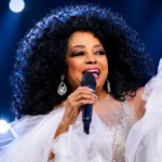 Diana Ross performing live on stage during a concert, featured in an article about Diana Ross Net Worth and her legendary music career.