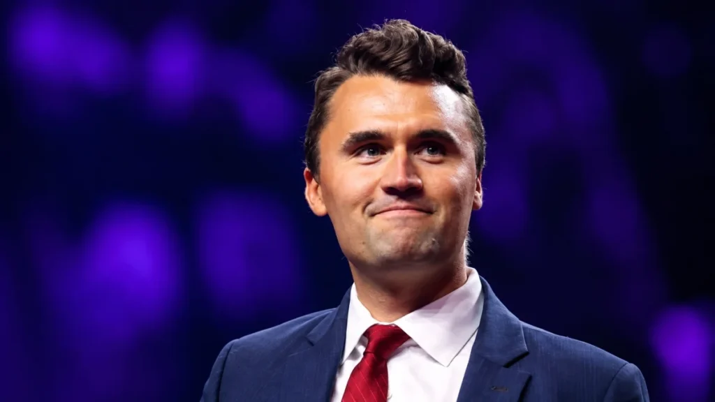 Charlie Kirk Net Worth portrait showing Charlie Kirk in a suit at a public event.