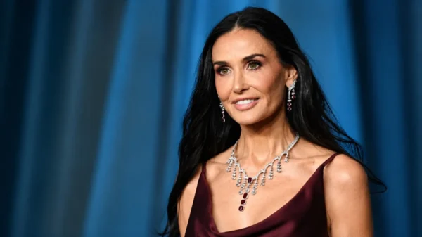 Demi Moore posing at a red carpet event for an article about Demi Moore Net Worth, her Hollywood career, wealth, and luxury lifestyle.