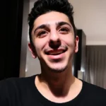 Faze Rug smiling in a close-up portrait for an article about Faze Rug Net Worth, YouTube career, earnings, and financial success.