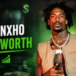 Hunxho Net Worth graphic showing the rapper with money, financial growth charts, and a wealth-themed background