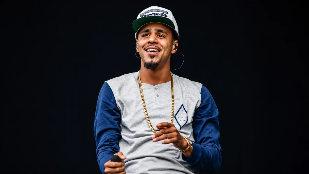 J Cole performing during the early stage of his music career, highlighting his early lifestyle, journey to fame, and J Cole Net Worth.