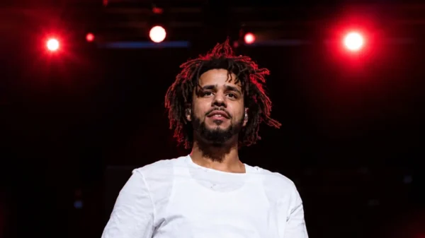 J Cole performing live on stage during a concert, highlighting J Cole Net Worth, music career, earnings, and financial success.