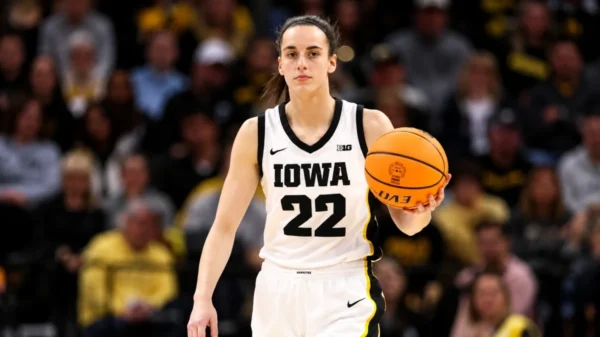Caitlin Clark Net Worth – Iowa basketball player holding a basketball during her college career.