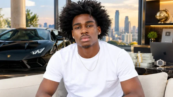 Kam Patterson Net Worth featuring Kam Patterson in a white T-shirt seated in a luxury interior with a black sports car and city skyline.